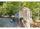 Charming backyard chicken coop with a run, nestled among lush green trees at 315 Vickers Ne Dr, Atlanta, GA 30307