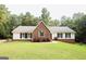 Brick ranch house with white accents and a well-manicured lawn at 2100 Martin Mill Rd, Moreland, GA 30259