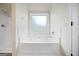 Clean bathroom with a large garden tub and tile surround at 2275 Lovejoy Rd # 72, Hampton, GA 30228