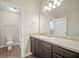 Bathroom boasts a vanity with granite countertop and dark brown cabinets at 2275 Lovejoy Rd # 72, Hampton, GA 30228
