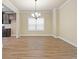 Empty dining room with hardwood floors, chandelier, and window with blinds at 2275 Lovejoy Rd # 72, Hampton, GA 30228