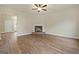 Living room with corner fireplace, hardwood floors, and ceiling fan at 2275 Lovejoy Rd # 72, Hampton, GA 30228