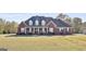 Brick home with a large front porch and landscaped yard at 395 W Mcintosh Rd, Brooks, GA 30205