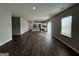 Open living room with hardwood floors and kitchen island at 846 Delft Way, Hampton, GA 30228