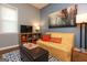 Small living room with a yellow couch and a modern wall art piece at 112 Parson St, Bowdon, GA 30108