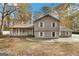 Two-story house with gray siding, a porch, and a driveway at 849 Wagon Wheel Cir, Fayetteville, GA 30214