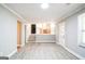 Living room with hardwood floors, stairs to kitchen, and white door at 849 Wagon Wheel Cir, Fayetteville, GA 30214