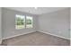 Well-lit bedroom featuring neutral walls, carpet, and two windows at 5374 Tolar Rd # 79, South Fulton, GA 30213