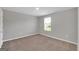 Simple bedroom with carpeted floor, neutral walls, and window with blinds at 5374 Tolar Rd # 79, South Fulton, GA 30213