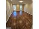 Large bedroom with hardwood floors and neutral color walls at 4010 Wembley Forest Way, Atlanta, GA 30340