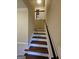 Well-lit staircase with dark wood steps and white risers at 4010 Wembley Forest Way, Atlanta, GA 30340