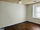 Simple bedroom with hardwood floors and a window at 7978 Woodlake Dr, Riverdale, GA 30274