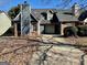 Two-story house with gray siding, brick base, and attached garage at 7978 Woodlake Dr, Riverdale, GA 30274