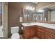 Bathroom with a corner vanity, toilet and brown walls at 200 Firefly Ct, Peachtree City, GA 30269