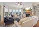 Bright living room features a fireplace, built-in shelving, and a bay window at 200 Firefly Ct, Peachtree City, GA 30269