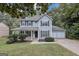 Charming two-story home with a covered front porch, manicured lawn, and a two-car garage at 565 Lake Joyce Ln, Fairburn, GA 30213