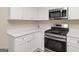 Close up on the kitchen with stainless steel oven and white countertops and cabinets at 565 Lake Joyce Ln, Fairburn, GA 30213