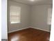 Bright bedroom with hardwood floors and two windows at 126 E Mimosa Dr, Jonesboro, GA 30236