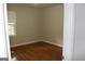 Simple bedroom with hardwood floors and neutral walls at 126 E Mimosa Dr, Jonesboro, GA 30236