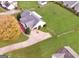 Aerial view of house with a large yard and driveway at 231 Ferguson Ave, Locust Grove, GA 30248