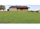 House sits on a large grassy lot with covered patio at 231 Ferguson Ave, Locust Grove, GA 30248