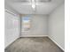 Bedroom with double door closet, window, and ceiling fan at 231 Ferguson Ave, Locust Grove, GA 30248