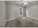 Bright bedroom with ceiling fan, large window, and carpet flooring at 231 Ferguson Ave, Locust Grove, GA 30248
