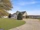 House exterior showcasing a carport and well-manicured lawn at 231 Ferguson Ave, Locust Grove, GA 30248