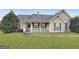 One-story house with gray siding, a covered porch, and a landscaped lawn at 231 Ferguson Ave, Locust Grove, GA 30248