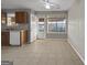 Kitchen with wooden cabinets, tiled floor, and access to backyard at 231 Ferguson Ave, Locust Grove, GA 30248