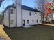 Rear view of a two-story house showcasing a large backyard at 485 Oxford Crest Ct, Lawrenceville, GA 30043