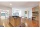 Open kitchen features an island and hardwood floors. Views into Gathering room at 307 Bradford Way, Peachtree City, GA 30269