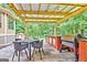 Outdoor kitchen with pergola, grill, and seating area at 307 Bradford Way, Peachtree City, GA 30269