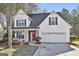 Two-story house with white siding, red brick accents, and a two-car garage at 409 St Dunstans Ct, Peachtree City, GA 30269