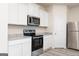 Modern kitchen with white cabinets, granite countertops, and stainless steel appliances at 137 Avondale Blvd, Conyers, GA 30013