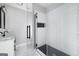 Contemporary bathroom with white tile, black accents, and glass shower at 944 Se Woodland Ave, Atlanta, GA 30316