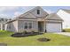 Gray house with white garage door and a tree at 145 Avondale Blvd, Conyers, GA 30013