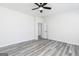 Bright bedroom featuring grey laminate flooring and ceiling fan at 3382 Arabian Farm Ln, Dacula, GA 30019