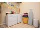 Bright laundry room with washer, dryer, and ample shelving at 417 Foggy Bottom Dr, Carrollton, GA 30116