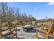 Cozy fire pit surrounded by rocking chairs on a paver patio at 109 Red Maple Drive, Peachtree City, GA 30269