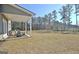 Spacious backyard with a large grassy area and mature trees at 371 Caledonia Ct N, Peachtree City, GA 30269