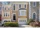Charming townhome featuring classic architectural details and a well-maintained front yard with a one-car garage at 3863 Meeting St, Duluth, GA 30096