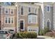Charming townhome featuring classic architectural details and a well-maintained front yard with a one-car garage at 3863 Meeting St, Duluth, GA 30096