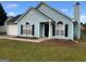 Charming light blue house with black shutters and a manicured lawn at 5879 Creekside Dr, Rex, GA 30273