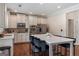 Modern kitchen with white cabinets, stainless steel appliances, and a large island at 7770 Stratford Manor Ln, Sandy Springs, GA 30350