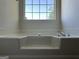 Bathroom features a soaking tub and a large window at 962 Spruce Pt, Jonesboro, GA 30238