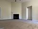 Bright living room featuring a fireplace and carpet flooring at 962 Spruce Pt, Jonesboro, GA 30238