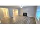 Living area with hardwood floors, fireplace, and access to other rooms at 320 Valley View Dr, Fairburn, GA 30213