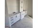 Double vanity bathroom with white cabinets and marble countertops at 115 Regina Ct, Fayetteville, GA 30215