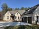 House exterior showcasing brick facade and three-car garage at 115 Regina Ct, Fayetteville, GA 30215